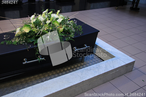 Image of Coffin with funeral flowers