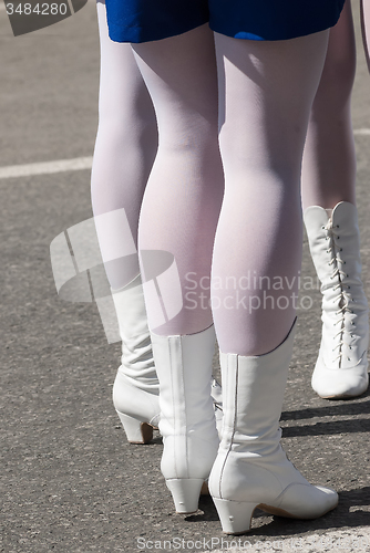 Image of Woman\'s legs in white boots