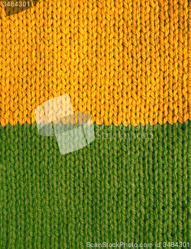 Image of Stocking stitch knitting in yellow and green stripes