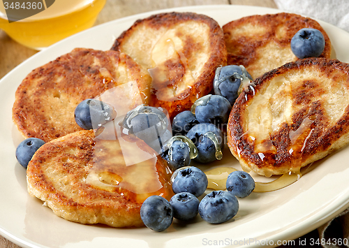 Image of Pancakes with honey and blueberries