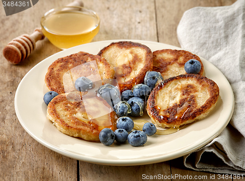 Image of Pancakes with honey and blueberries