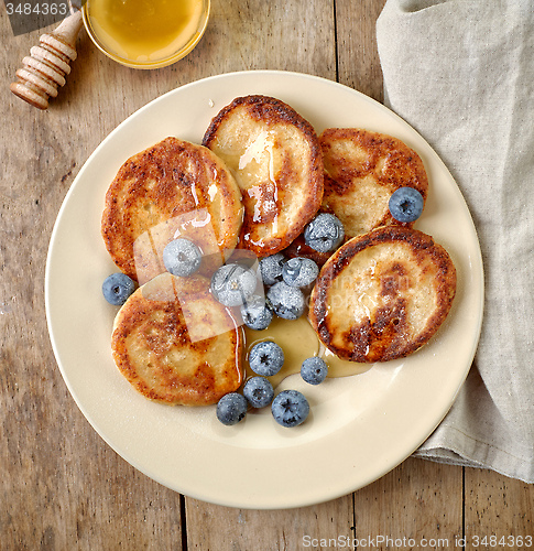 Image of Pancakes with honey and blueberries