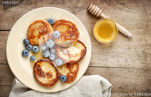 Image of Pancakes with honey and blueberries