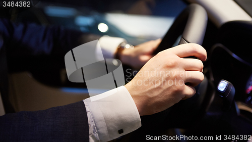 Image of hands on a steering wheel