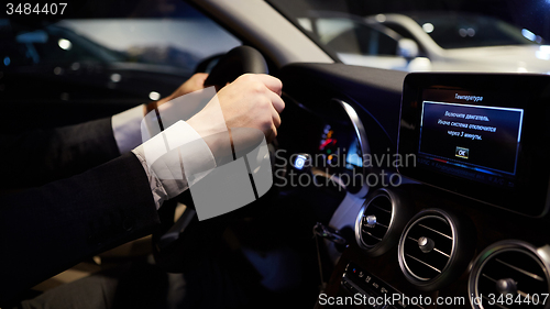 Image of hands on a steering wheel