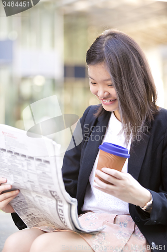 Image of Young Asian female business executive using laptop