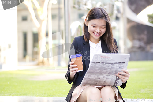 Image of Young Asian female business executive using laptop