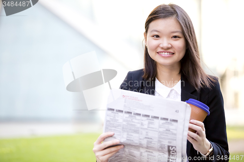 Image of Young Asian female business executive using laptop