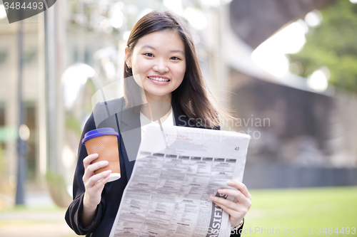 Image of Young Asian female business executive using laptop