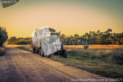 Image of Old tractor with hay bales