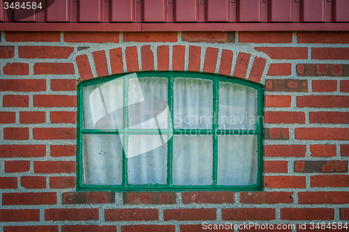 Image of Green window on a brick wall