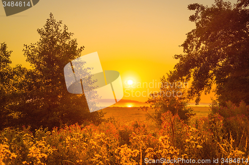 Image of Sunrise over a lake with trees