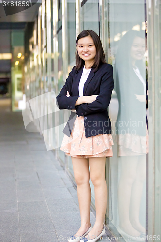 Image of Young Asian female business executive smiling portrait