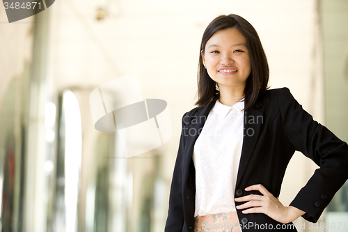 Image of Young Asian female business executive smiling portrait