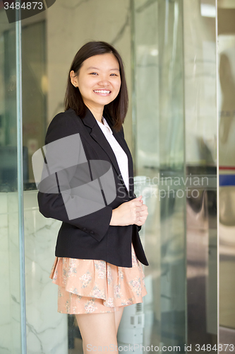 Image of Young Asian female business executive smiling portrait