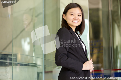 Image of Young Asian female business executive smiling portrait