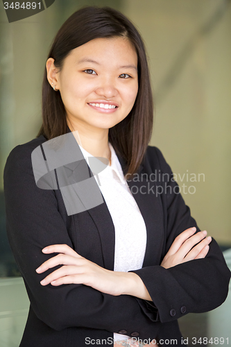 Image of Young Asian female business executive smiling portrait