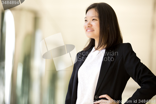 Image of Young Asian female business executive smiling portrait