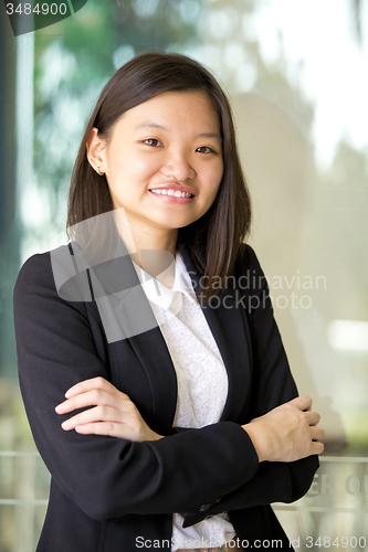 Image of Young Asian female business executive smiling portrait