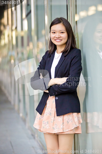 Image of Young Asian female business executive smiling portrait