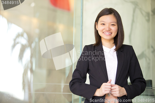 Image of Young Asian female business executive smiling portrait