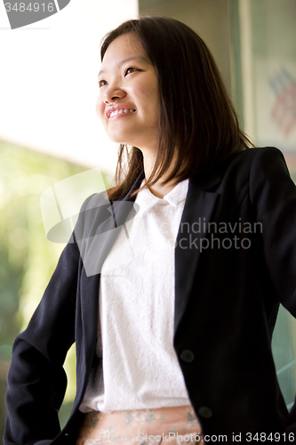 Image of Young Asian female business executive smiling portrait