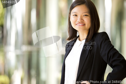 Image of Young Asian female business executive smiling portrait