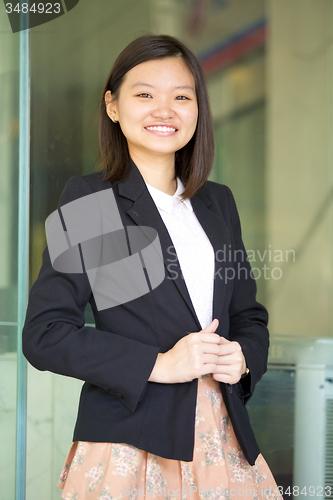 Image of Young Asian female business executive smiling portrait