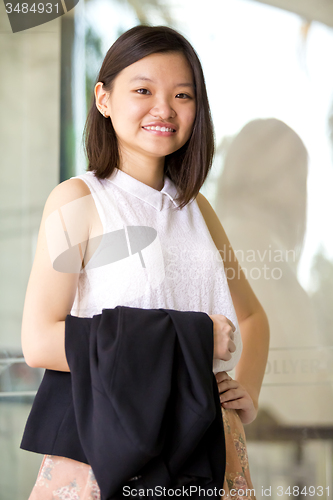 Image of Young Asian female business executive smiling portrait