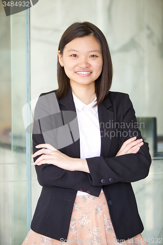 Image of Young Asian female business executive smiling portrait