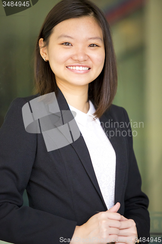 Image of Young Asian female business executive smiling portrait