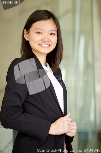 Image of Young Asian female business executive smiling portrait