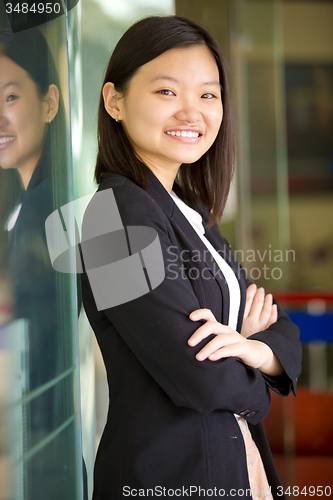 Image of Young Asian female business executive smiling portrait