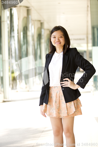 Image of Young Asian female business executive smiling portrait