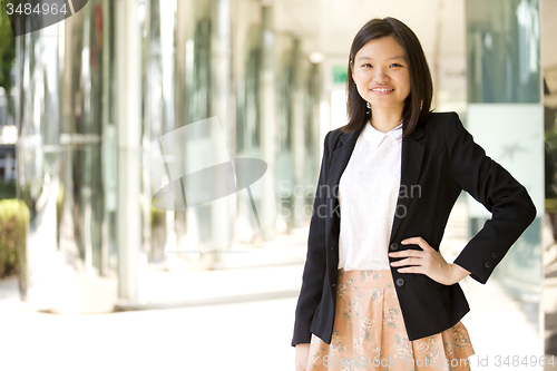 Image of Young Asian female business executive smiling portrait