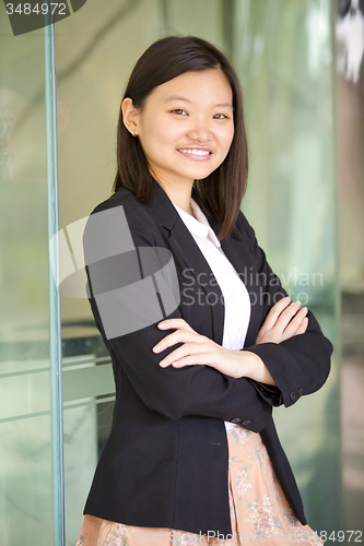 Image of Young Asian female business executive smiling portrait