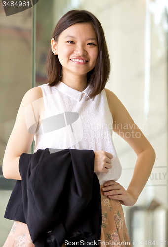 Image of Young Asian female business executive smiling portrait