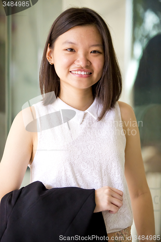 Image of Young Asian female business executive smiling portrait