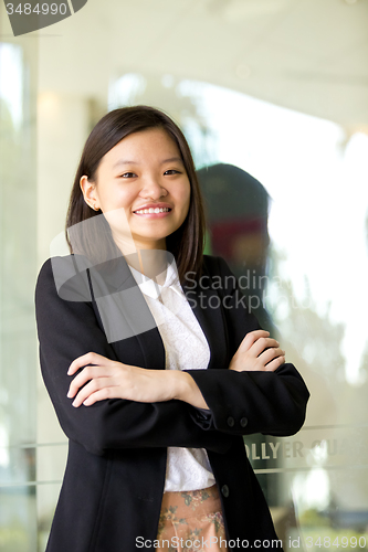 Image of Young Asian female business executive smiling portrait