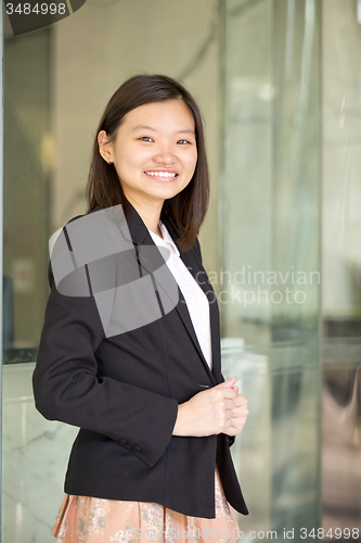 Image of Young Asian female business executive smiling portrait