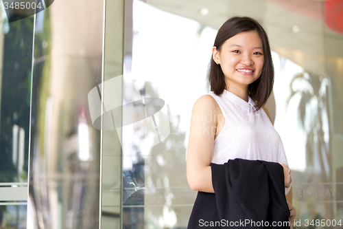 Image of Young Asian female business executive smiling portrait