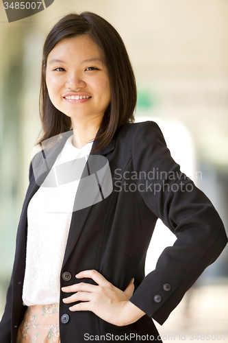 Image of Young Asian female business executive smiling portrait