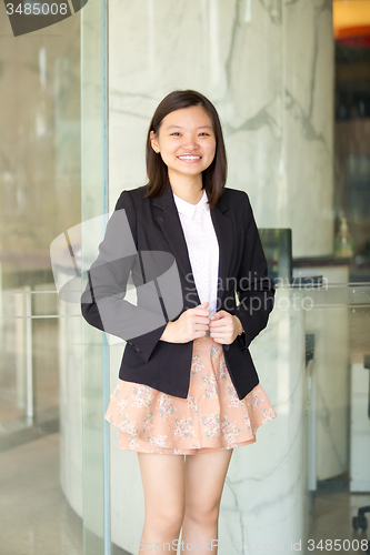 Image of Young Asian female business executive smiling portrait