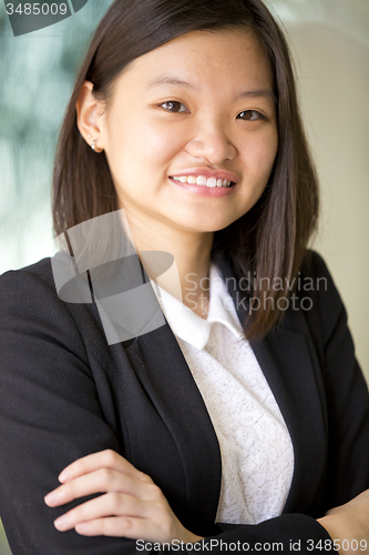 Image of Young Asian female business executive smiling portrait