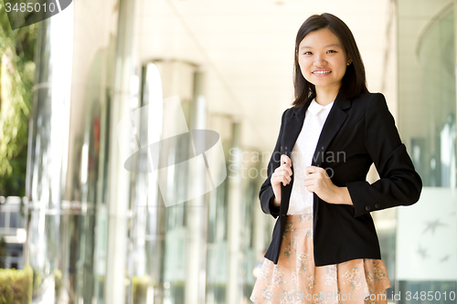 Image of Young Asian female business executive smiling portrait