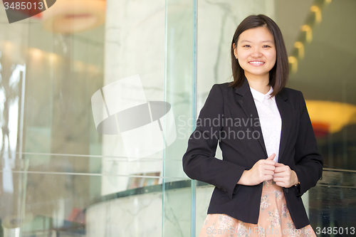 Image of Young Asian female business executive smiling portrait