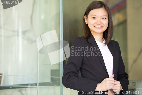 Image of Young Asian female business executive smiling portrait