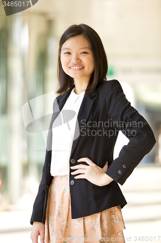 Image of Young Asian female business executive smiling portrait