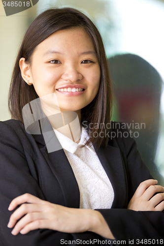 Image of Young Asian female business executive smiling portrait