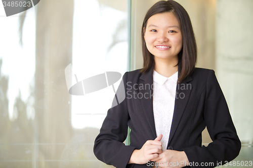 Image of Young Asian female business executive smiling portrait